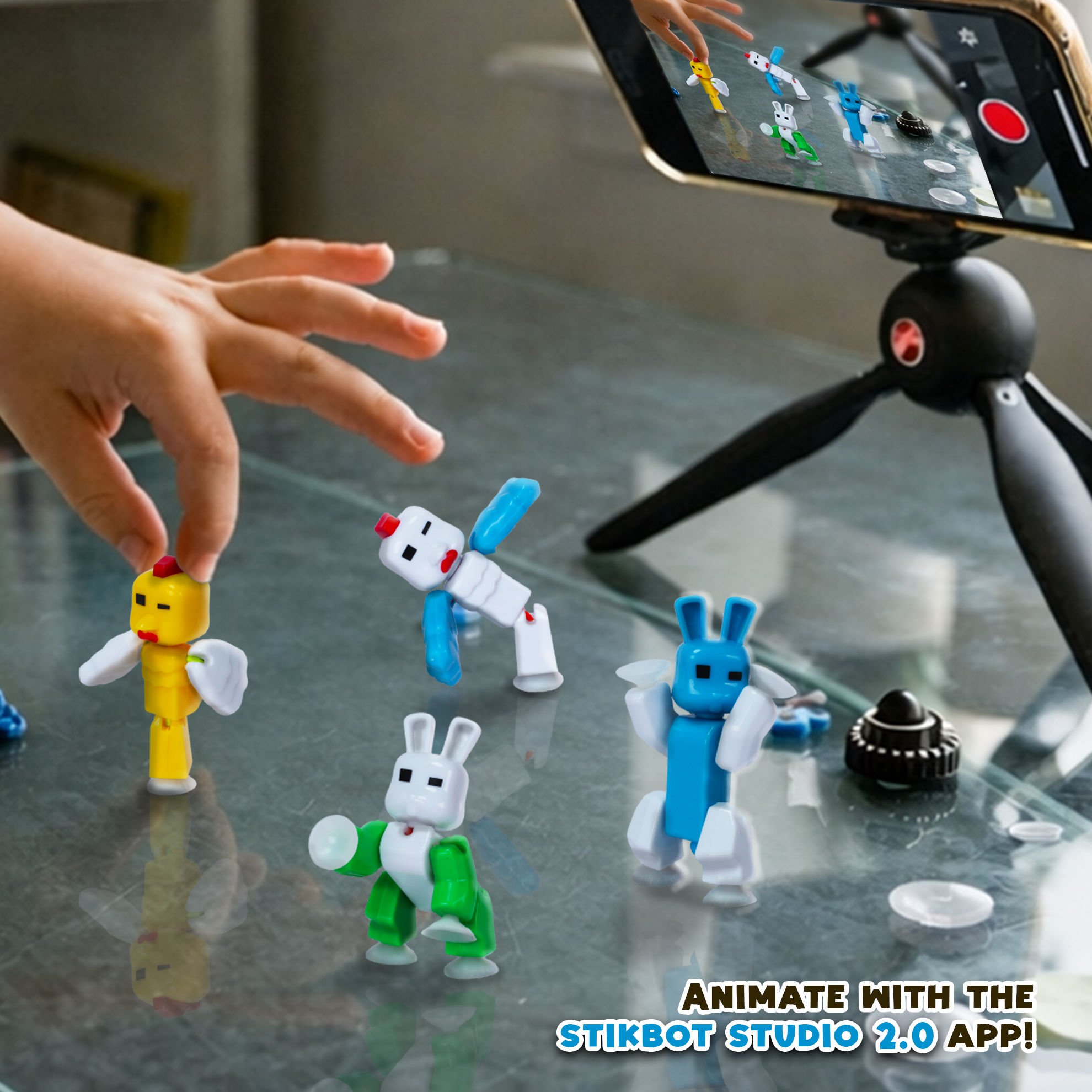 Kids creating stop motion animation with StikBot animal figures using smartphone and tripod
