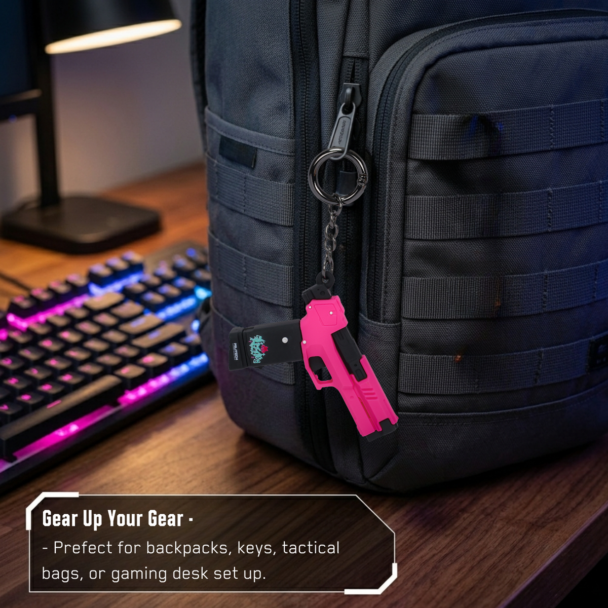 Pink Cyberpunk 2077 Lizzie pistol keychain clipped to a black backpack beside a gaming keyboard